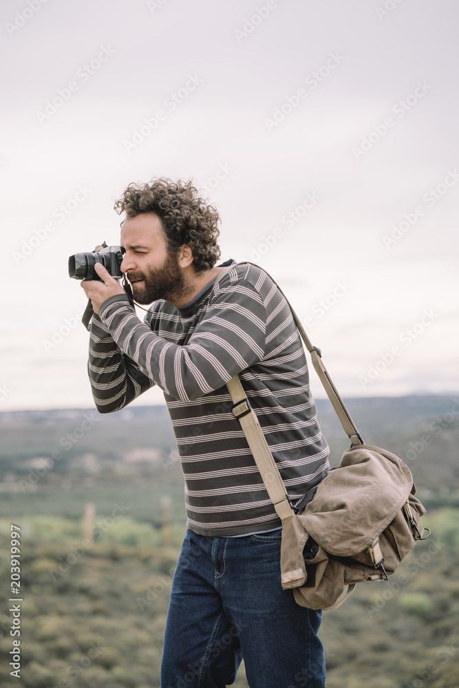 Man photojournalist poses with his photo camera Man photojournalist poses with his photo camera