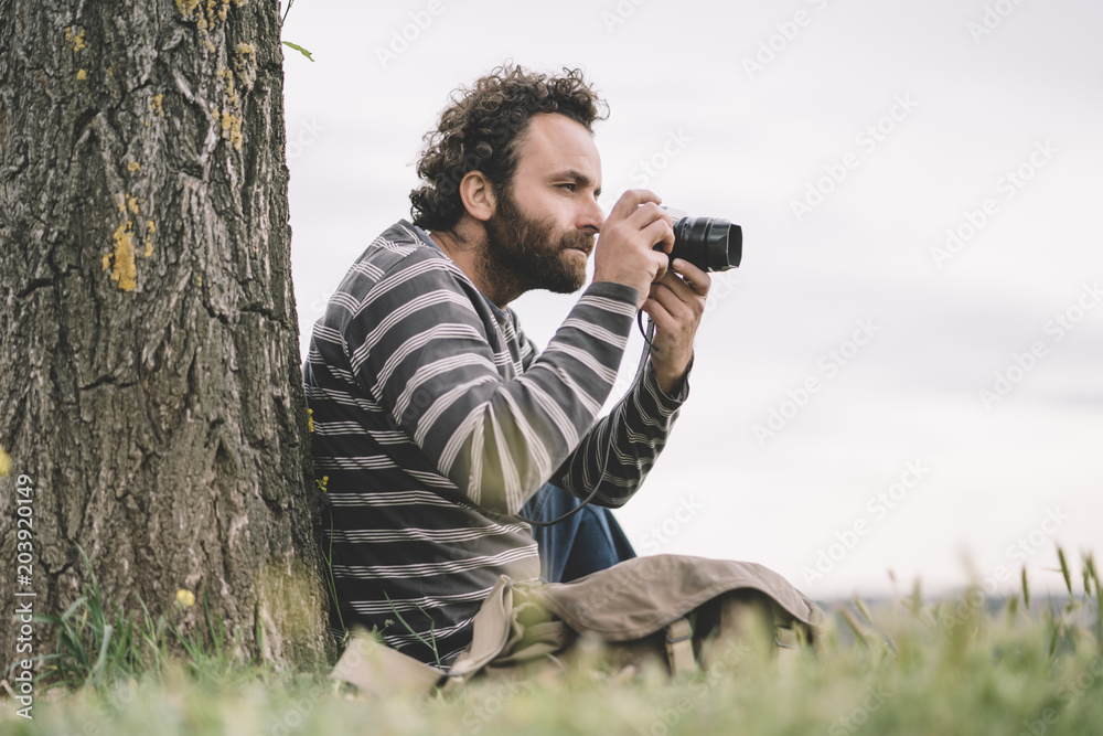 Man photojournalist poses with his photo camera Man photojournalist poses with his photo camera