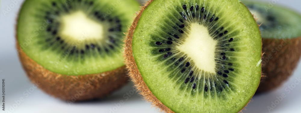 Ripe whole kiwi fruit and half kiwi fruit on white background Ripe whole kiwi fruit and half kiwi fruit on white background