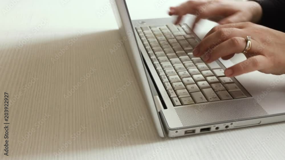 female hands typing on a computer keyboard female hands typing on a computer keyboard