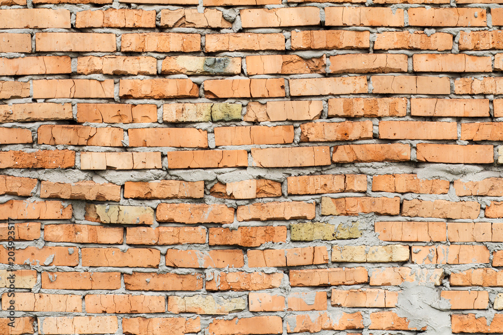 Fototapeta premium Red brick wall with smeared cement solution