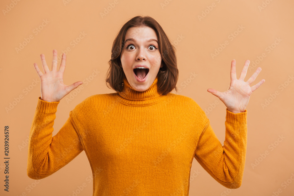 Portrait of an excited young woman in sweater