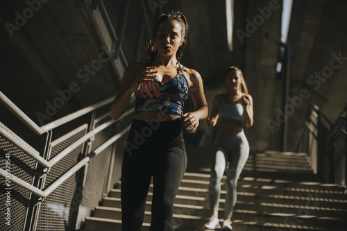 Young women running alone down stairs