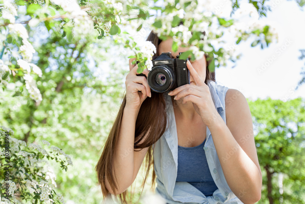 Female photographed nature with retro old camera Female photographed nature with retro old camera