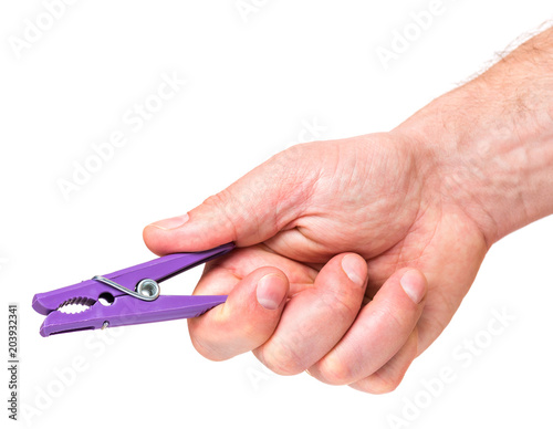 Color clothespin in male hand isolated on white background. Man hand with colourful clothes-pin - close-up.