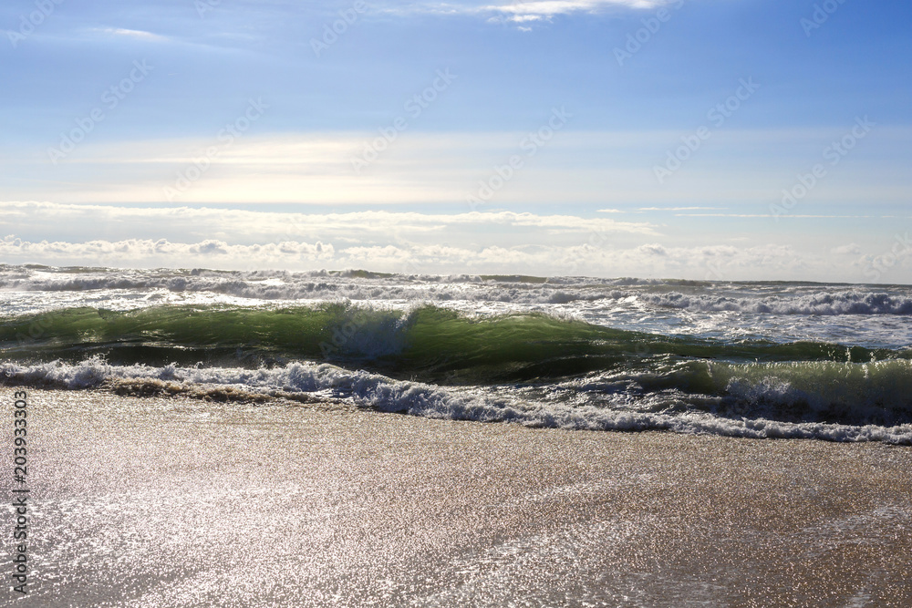 Beautiful ocean waves on the sand beach.