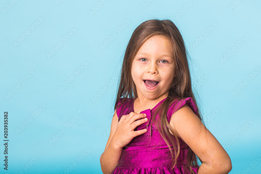 cute cheerful little girl portrait, isolated on blue background cute cheerful little girl portrait, isolated on blue background