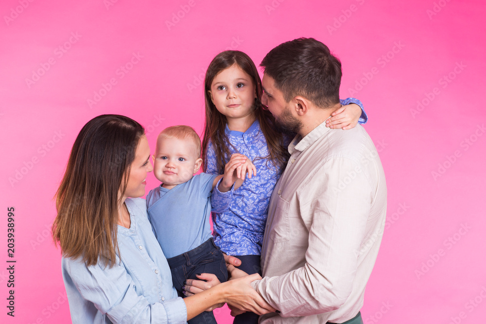 Happy mixed race family portrait smiling on pink background Happy mixed race family portrait smiling on pink background