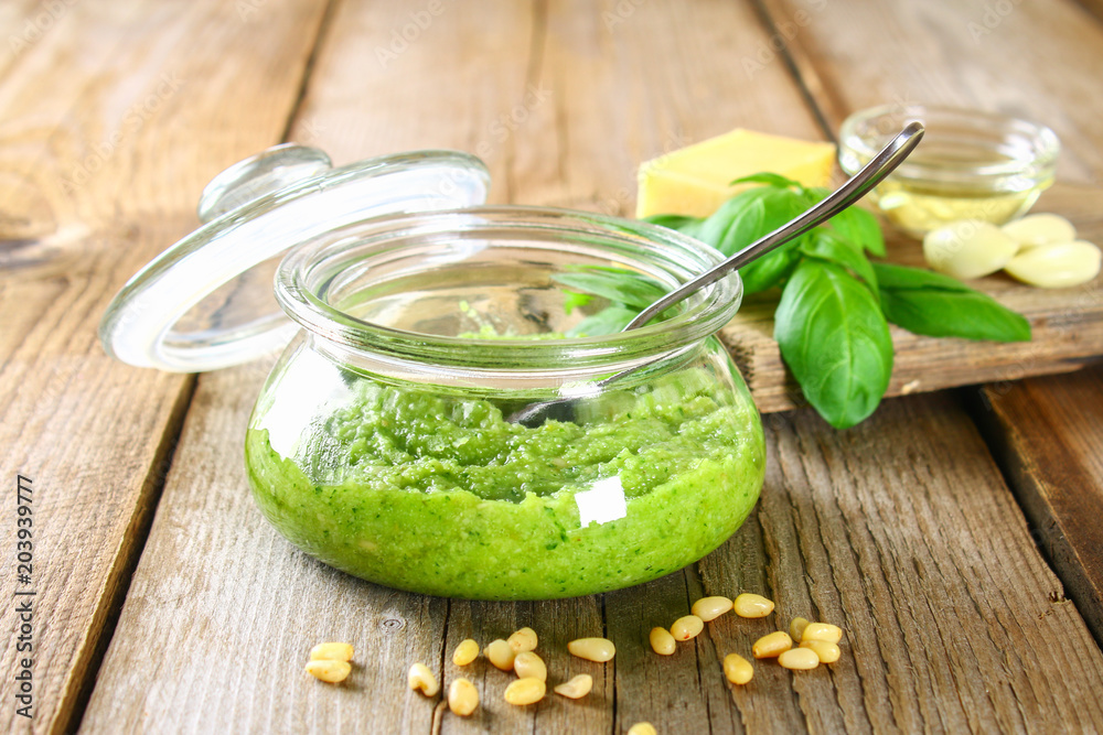 Homemade pesto sauce. Ingredients. Cheese, garlic, basil, pine nuts, olive oil on an old wooden table. Homemade pesto sauce. Ingredients. Cheese, garlic, basil, pine nuts, olive oil on an old wooden table.