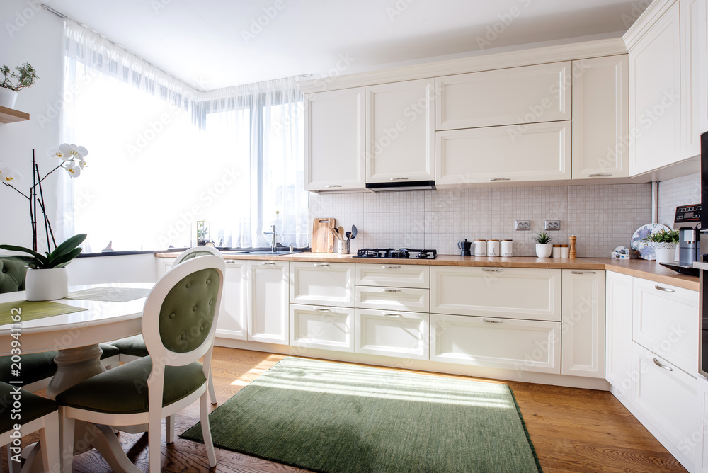 Wonderful kitchen interior with natural light and modern wooden furniture. Hardwood floors and modern appliances