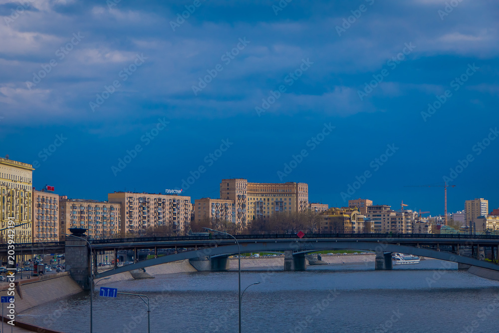 Outdoor panoramic view of Moscow and bridge over the Moskva River in conecting modern skyscrapers of Moscow-City. Landscape and cityscape of Moscow in cloudy sky Outdoor panoramic view of Moscow and bridge over the Moskva River in conecting modern skyscrapers of Moscow-City. Landscape and cityscape of Moscow in cloudy sky