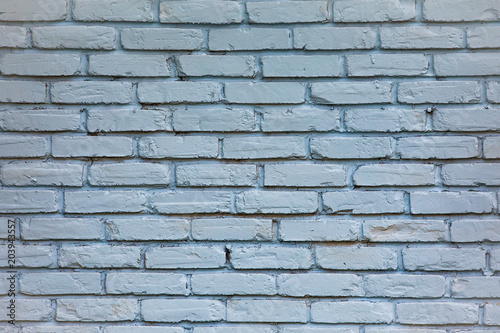 old  blue toned brick wall with repeating pattern
