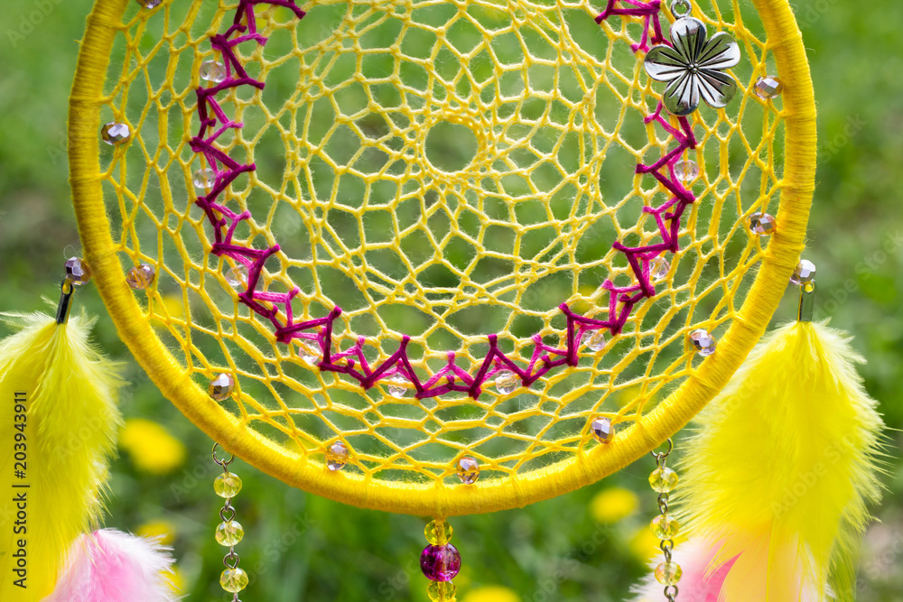 Naklejka premium Handmade dream catcher with feathers threads and beads rope hanging