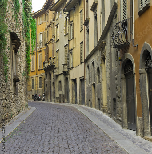 Fototapeta Naklejka Na Ścianę i Meble -  narrow street with cobblestone in Bergamo old city, Italy