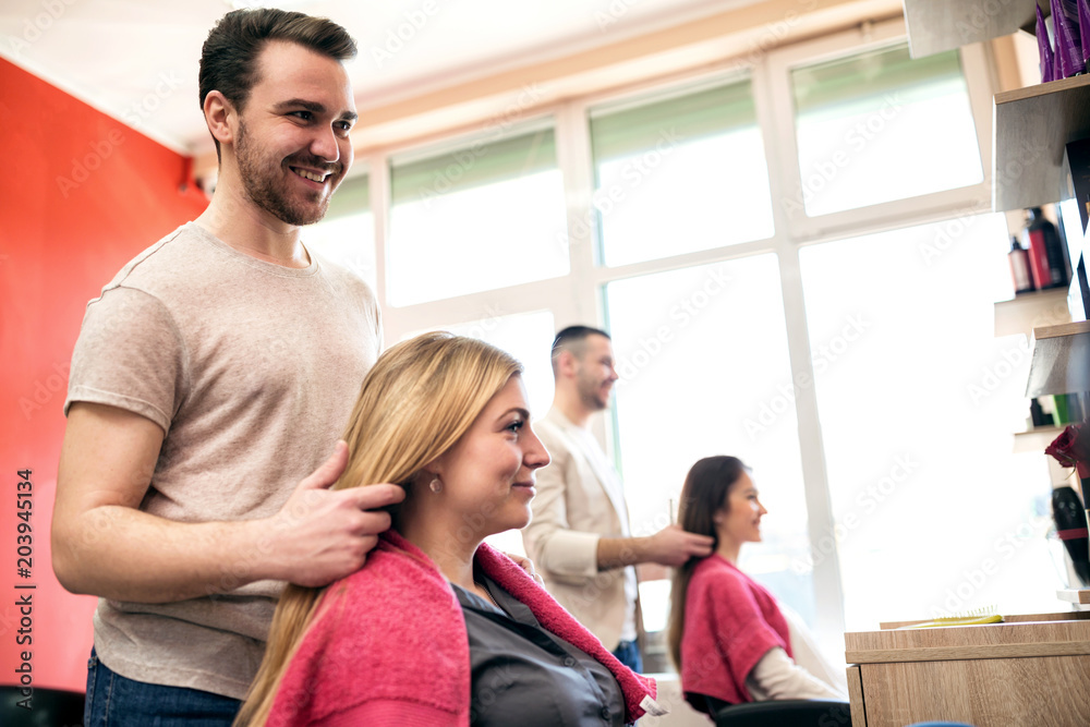 Smiling hairdresser and customer in hair salon Smiling hairdresser and customer in hair salon