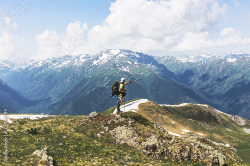 Man traveler backpacker with GPS navigator, pointing way trekking pole.