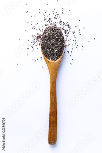 Spoon full of chia grains on white background