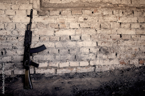 submachine gun kalashnikov AK-47 against the wall photo