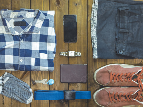 top down overhead view of stylish men clothes accessories on a wooden background