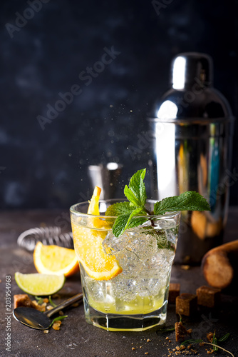 Orange cocktail with ice, leaf of mint and orange slice.