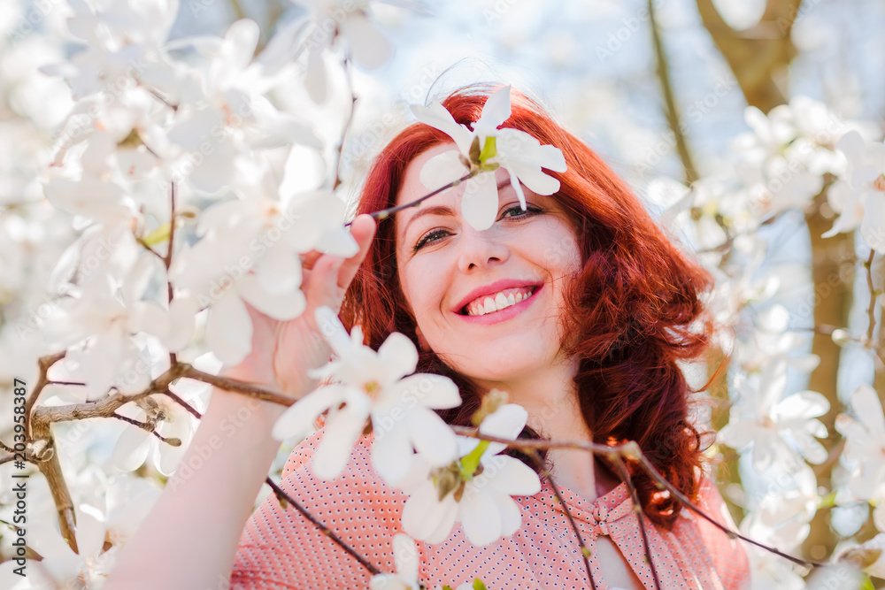 Fototapeta premium portrait of a beautiful woman with flowering tree