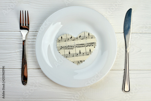 Photography Paper heart with musical notes on white plate