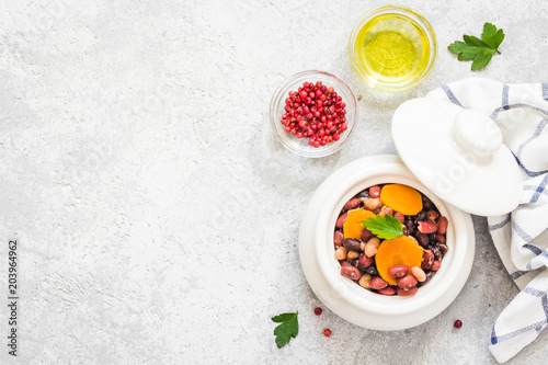 Mexican beans in a pot on concrete background. Top view, space for text. 