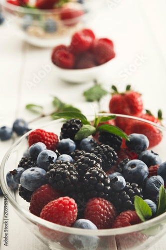 Mixed berries in glass bowls closeup  selective focus