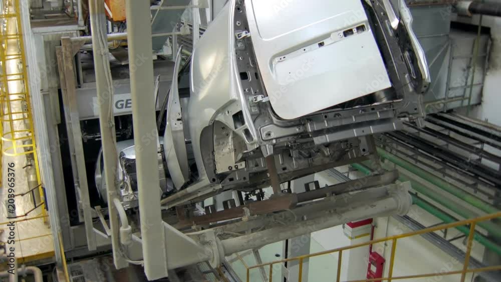 car bodies are moving over conveyor tape in a workshop of car factory car bodies are moving over conveyor tape in a workshop of car factory