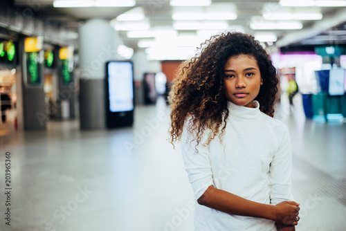 Portrait of a mixed race girl with gorgeous curly hair. Looking at camera.