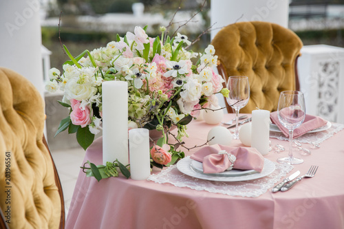 Beautiful wedding table that decorated with flower arrangements and candles.