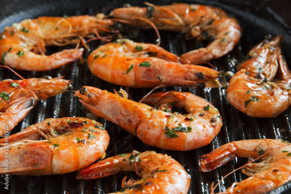 grill fried shrimps in a grill pan close-up top view