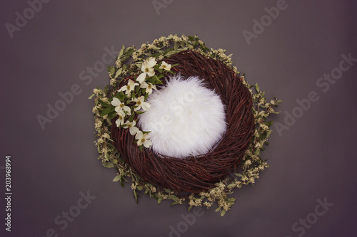 cozy fantasy nest with soft bedding and decorative white flowers on gray background