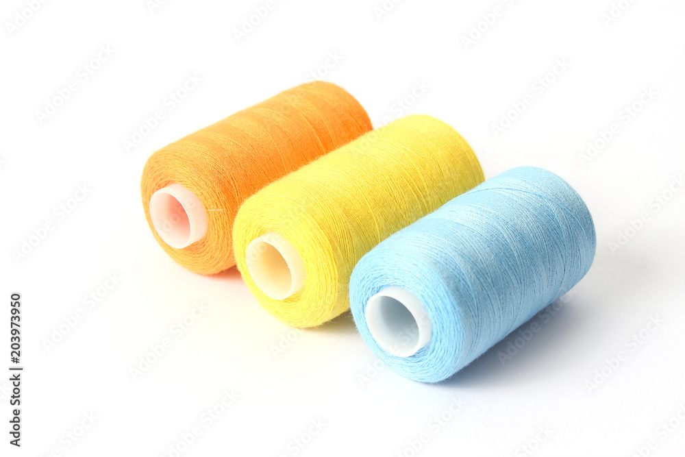 sewing thread of different colors isolated on white. sewing thread of different colors isolated on white.