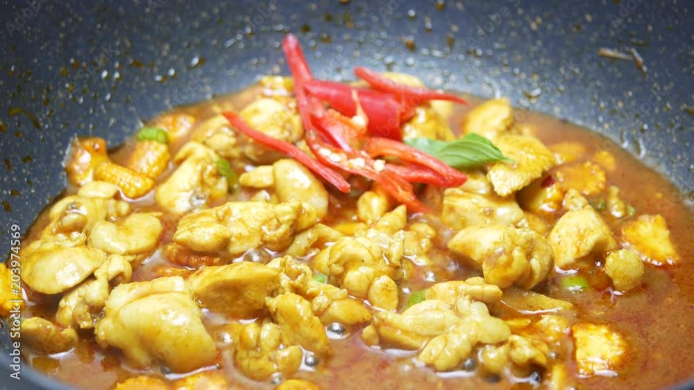put sweet basil , bell pepper into the black teflon pan which stir fried chicken , sliced corn and long yard beans,  spices , curry paste and  food palm oil  in the pan