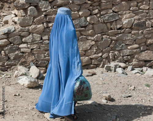 Woman walking in the streets of Kabul in burqa