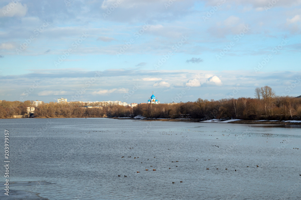 Panoramic view of Moskva river with crosses on dome of Nikolo-Perervinsky Monastery on the horizon, Kolomenskoye, Moscow, Russia, beautiful spring landscape on bright sunny day in March