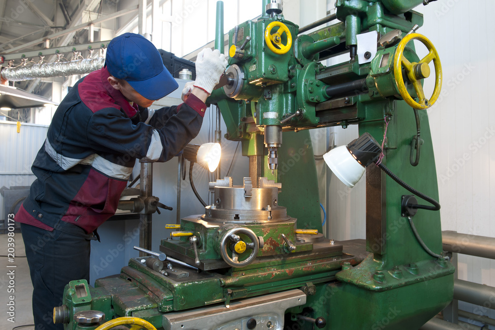 Worker at a machine tool. Worker at a machine tool.