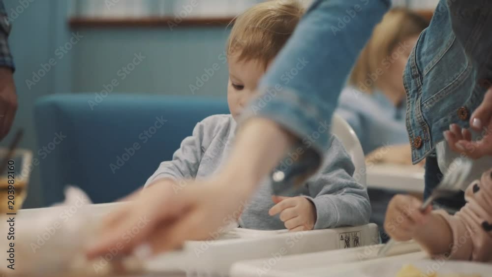 children eat at a cafe with parents