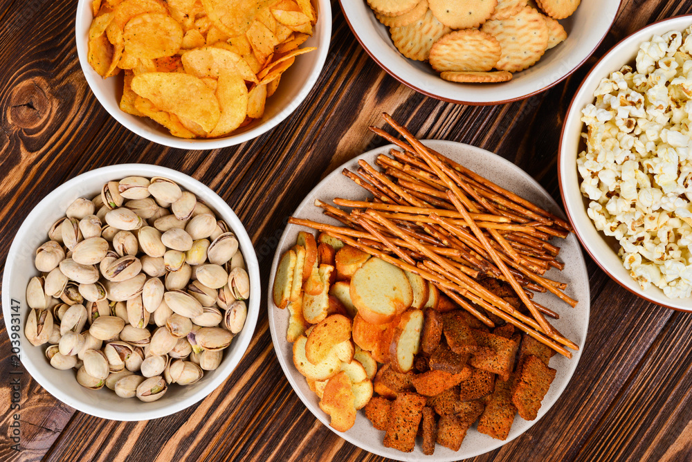 Snacks on a wooden background. Space for text or design. Snacks on a wooden background. Space for text or design.