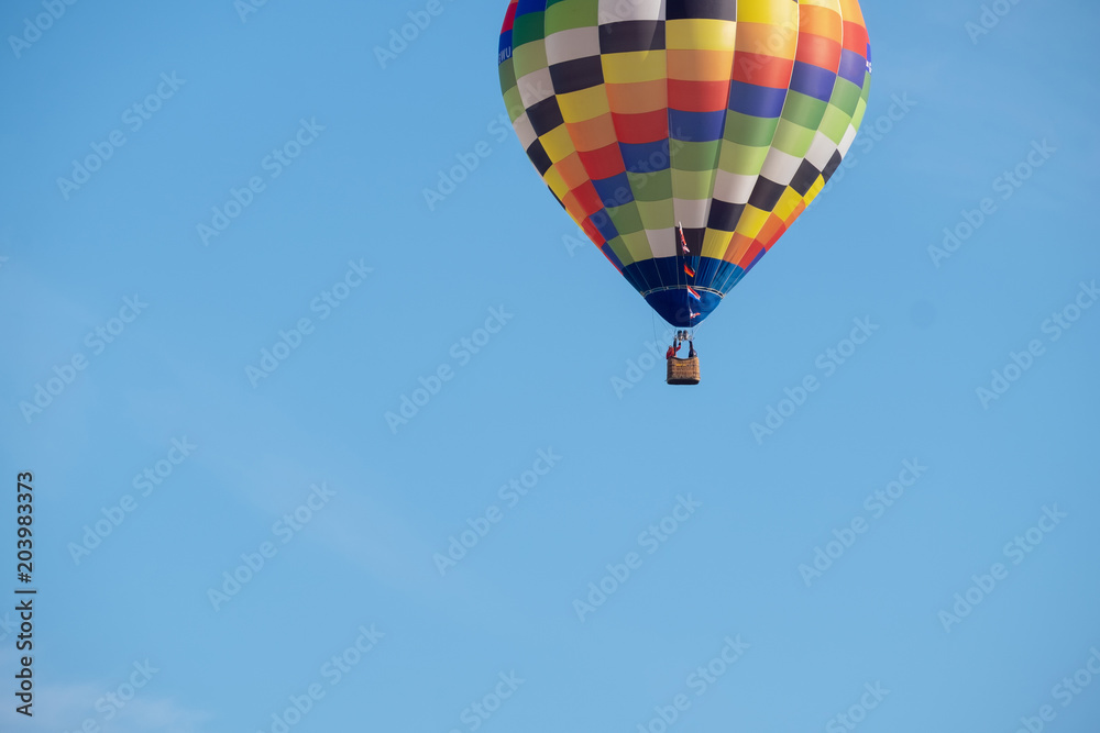 Naklejka premium Hot-air balloon in flight nears the ground, It stated to lose altitude as there was a instructing pilot on board learning soft landings. 