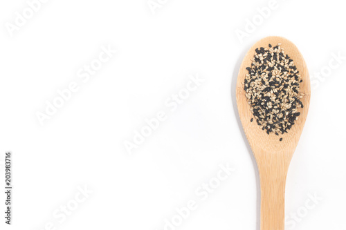 White and black sesame in a spoon