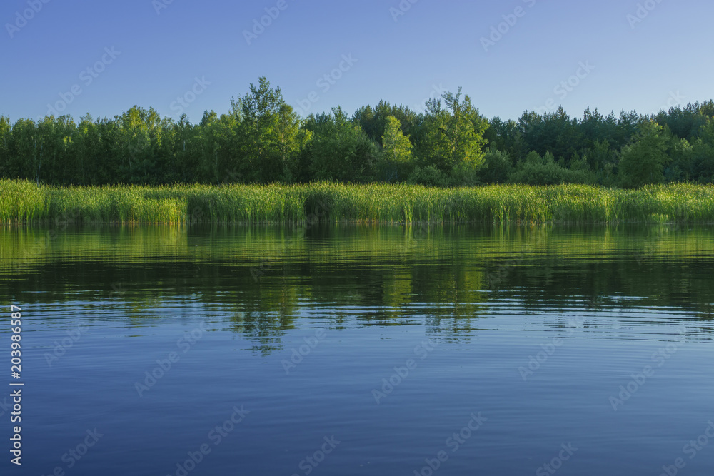 Simple landscape of lake with shore reflection Simple landscape of lake with shore reflection
