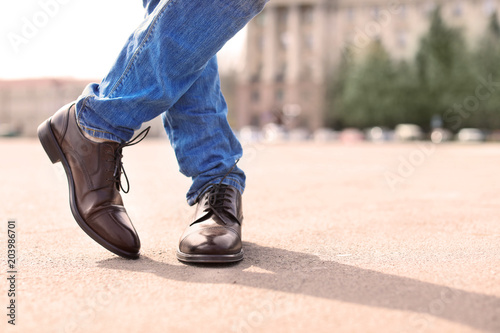 Man in elegant leather shoes outdoors, closeup