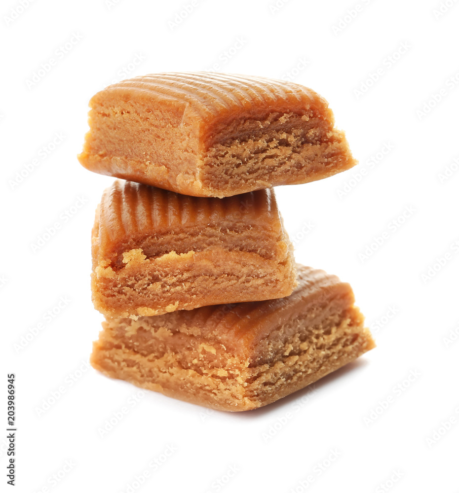 Delicious caramel candies on white background Delicious caramel candies on white background