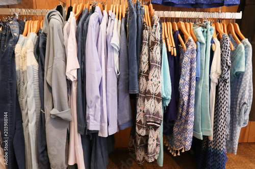 Fashionable clothes in a boutique store multicolored womens clothing hanging on the hanger © OceanProd
