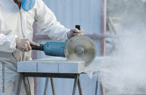 Worker cuts stone grinding machine