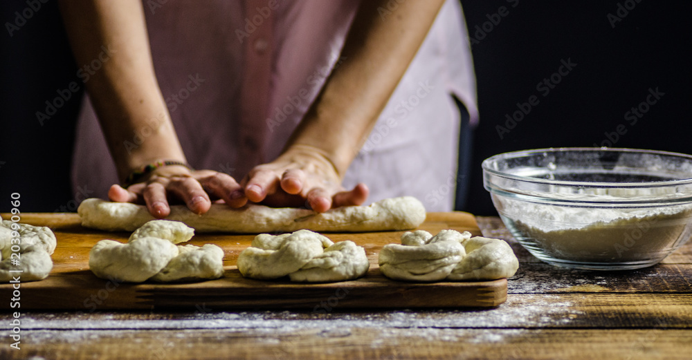 Dough dainted by the woman on the board
