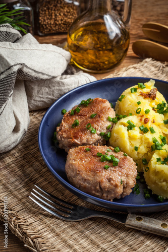 Meatballs served with boiled potatoes.