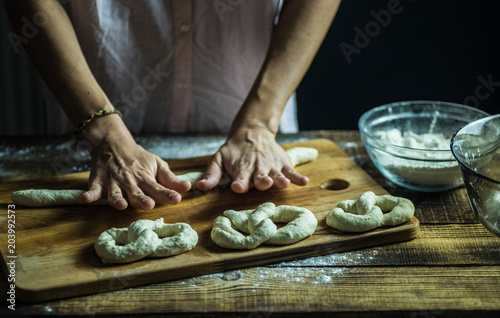 Dough dainted by the woman on the board
